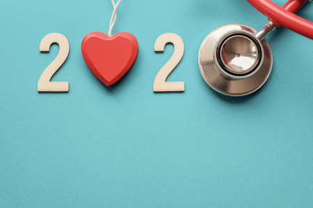 2020 wooden number with red stethoscope. Happy New Year for heart health and medical concept, life...