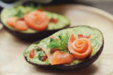 Avocado boats stuffed with smoked salmon rose salad, healthy low carb ketogenic foodの写真素材