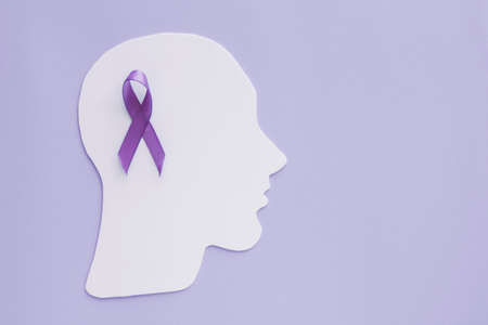 brain paper cutout with purple ribbon on purple background, Epilepsy and alzheimer awareness, seizure disorder, mental health conceptの写真素材