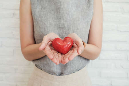 woman holding red heartの写真素材