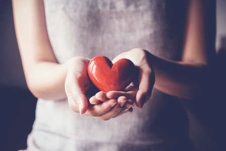 woman holding red heartの写真素材