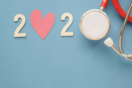 2020 wooden number with red stethoscope. Happy New Year for heart health and medical concept, life insurance businessの写真素材