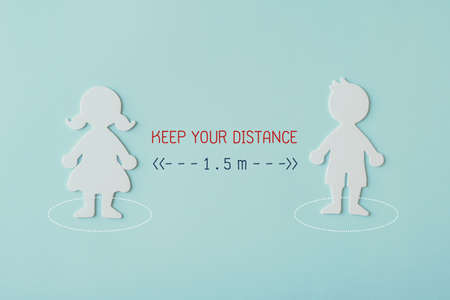 Boy and girl student paper cut with word keep your distance 1.5m,  returning back to school, school reopening post covid-19 coronavirus pandemic, new normal conceptの写真素材