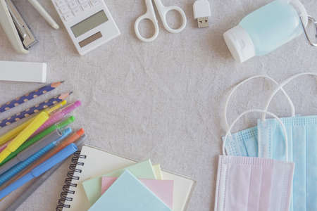 School stationery supplies, medical masks and hand gel sanitizer, school reopening, returning back to school after covid-19 coronavirus pandemic is over, new normal conceptの写真素材