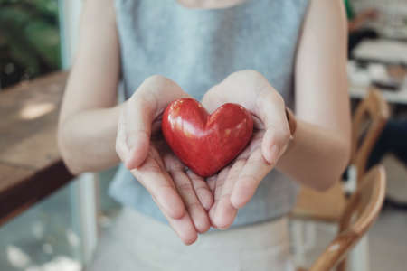 Asian woman holding red heart, health insurance, donation charity conceptの写真素材