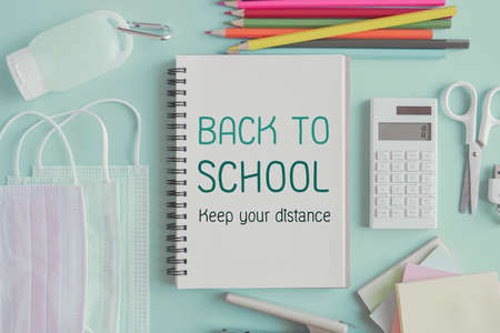 School stationery supplies, medical masks and hand gel sanitizer, school reopening, returning back to school after covid-19 coronavirus pandemic is over, new normal conceptの写真素材