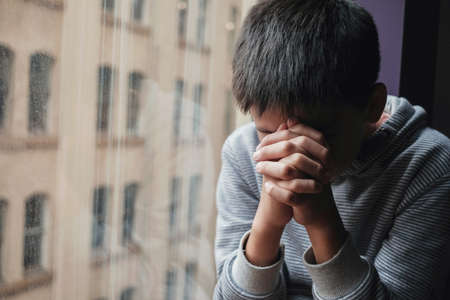 Mixed asian preteen tween boy hands closed praying, child religion, christianity faith concept, Hope, World Day of Prayer,international day of prayer, social distancingの写真素材