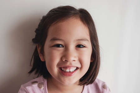 Portrait of happy Asian young little girl smilingの写真素材