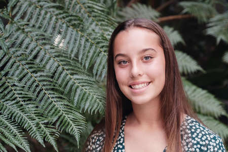 Close up portrait of a confident, charming and gorgeous mixed multicultural blue eyes teen girl over...