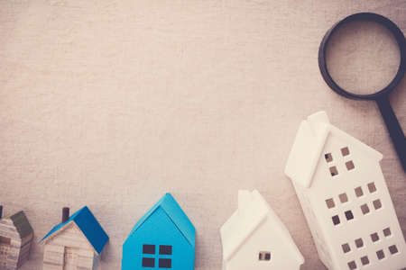 model blue and white houses and magnifying glass, picking the right house property, house searching, home insurance conceptの写真素材