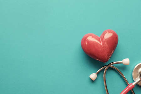 Red heart with stethoscope on blue background, heart health,  health insurance concept, World heart day, world health dayの写真素材