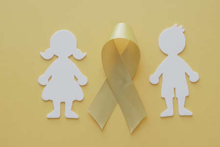 Boy and girl paper cut with yellow gold ribbon, Sarcoma Awareness, Bone cancer, childhood cancer awareness, World Suicide Prevention Day, September yellowの写真素材