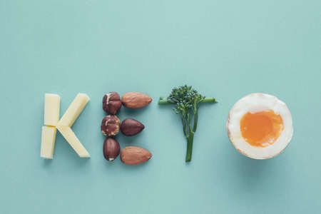 Keto word made from Ketogenic diet, low carb, healthy food on blue pastel backgroundの写真素材