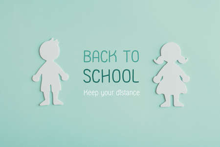 Boy and girl student paper cut with word Back to school, keep your distance, school reopening after covid-19 coronavirus is over, new normal conceptの写真素材