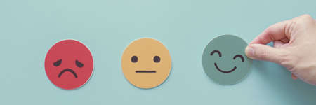 Hand choosing green happy smile face paper cut, feedback rating and positive customer review,...