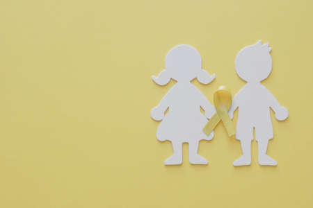 Boy and girl paper cut with yellow gold ribbon, Sarcoma Awareness, Bone cancer, childhood cancer awareness, World Suicide Prevention Day, September yellowの写真素材