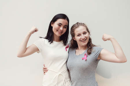 multicultural young women with pink ribbons, breast cancer awareness, October pink conceptの写真素材