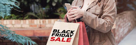 young women carrying shopping bags and shopping online, Black friday sale conceptの写真素材