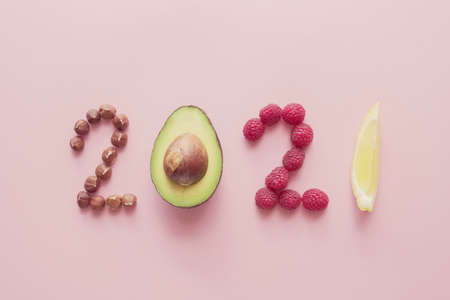 2021 made from healthy food on pink background, Happy New year, health diet resolution, goals and...