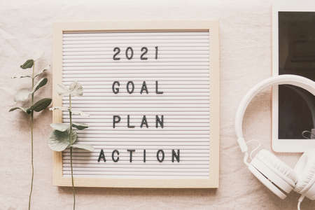 2021 New year resolution, Goal, Plan and action on letter board with tablet and headphoneの写真素材