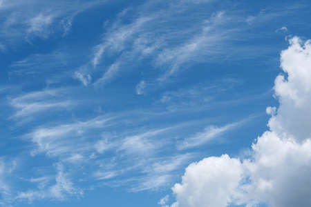 Beautiful wispy cirrus and fluffy cumulus clouds in blue sky on freedom, energize and joyful sunny dayの写真素材