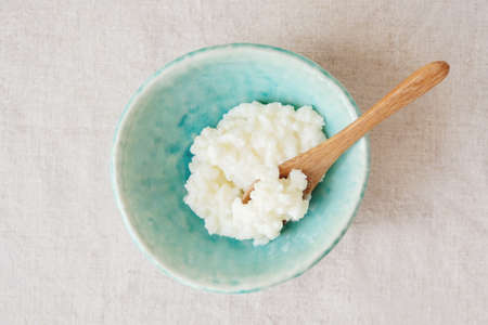 Organic probiotic milk kefir grains, Tibetan mushrooms in blue bowlの写真素材
