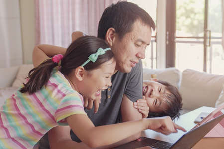 Father working from home with children. Homeschooling, stay home, social distancing during coronavirus quarantine isolation, freelance job conceptの写真素材