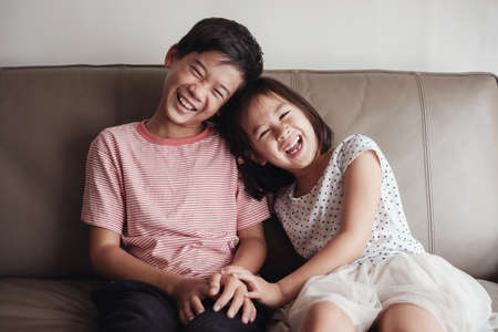Asian little brother and sister at home , Happy children portraitの写真素材