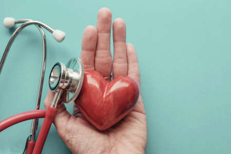 Red heart on hand with stethoscope, heart health,  health insurance concept, World heart day, world health dayの写真素材