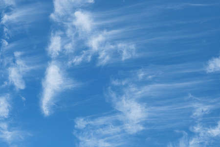 Beautiful wispy cirrus clouds in blue sky on freedom, energize and joyful sunny dayの写真素材