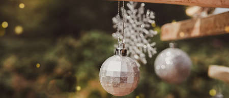 Christmas decoration silver bauble ball on eco reusable rustic tree, festive backgroundの写真素材
