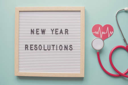 New Year Resolutions on letter board with heart and  stethoscope, health and wellbeing 2021 goalsの写真素材