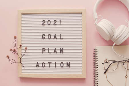 2021 New year resolution, Goal, Plan and action on letter board with notepad and headphoneの写真素材
