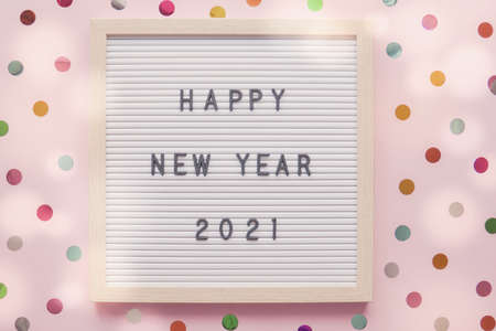 Happy New Year 2021 on letter board with colorful dot pink pastel backgroundの写真素材