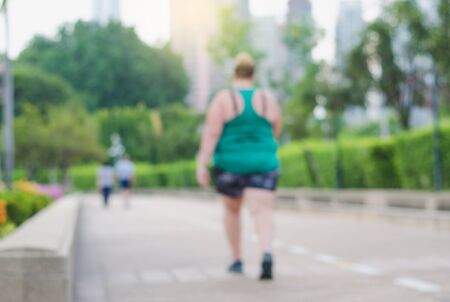 blur fat woman and people running in the park at morning.