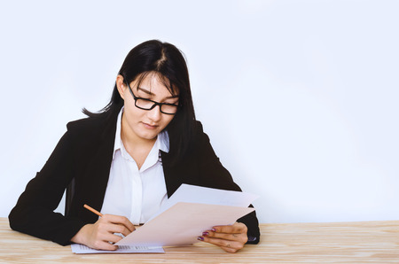 attractive business woman wearing eyeglasses thoughtful thinking about work in new project.の写真素材