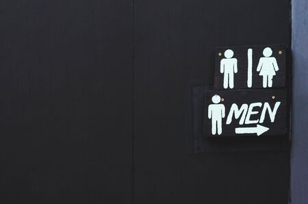 White text toilet sign in dark board on dark wall all that made from wooden.の写真素材