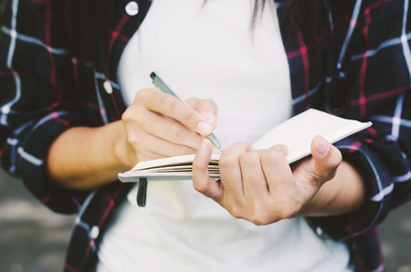 gorgeous woman hand use pen writing on notebook paper for memo.の写真素材