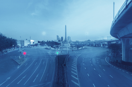 empty middle of metropolis with building at morning on holiday in Thailand. traffic not jam on empty road.の写真素材