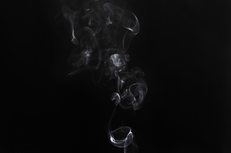 abstract movement of white smoke in dark background.の写真素材