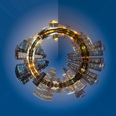 circle polar of modern building bright in night city with skyline symmetric water mirror reflection. night cityscape concept.の写真素材