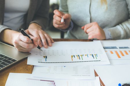 two attractive business woman teamwork working on table with strategy and analyze from document for decision in planning new project.の写真素材