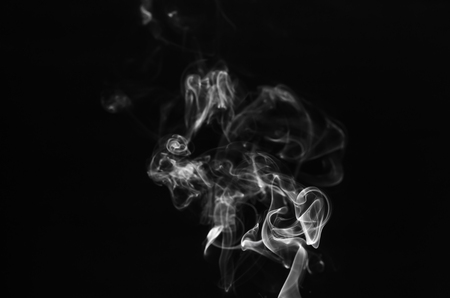 abstract of white smoke in dark background with smooth motion flowing.の写真素材