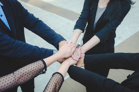 teamwork concept of diverse multiethnic business people with group hands put and stack holding with...