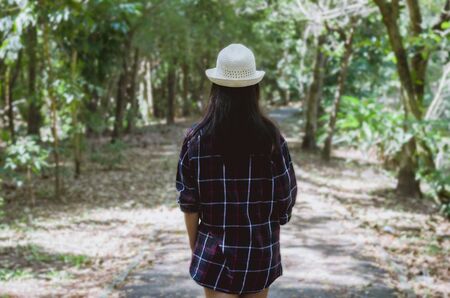 beautiful woman traveler standing looking forward ready to go to hiking travel walking in to forest. holiday adventure trekking and camping outdoor concept.の写真素材