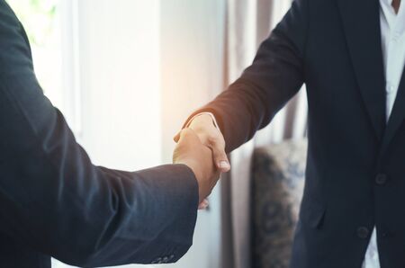 attractive business man hand shaking for complete business deal together successful. teamwork concept. partnership concept and dealership concept.の写真素材
