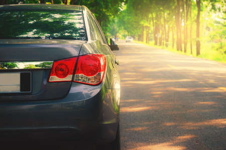 Tail light of a car isolated on asphalt roadの写真素材