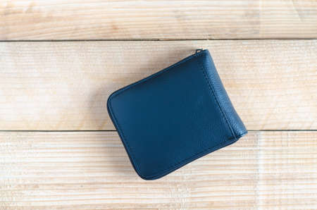 modern black leather wallet on wooden table background. wealth, saving, money, finance and investment concept.の写真素材