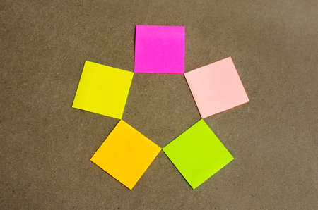 colorful blank sticky note or empty post notes advertisement top view lay star shape on cork board for reminder remember on working or appointment with customer, coworker, supplier.の写真素材