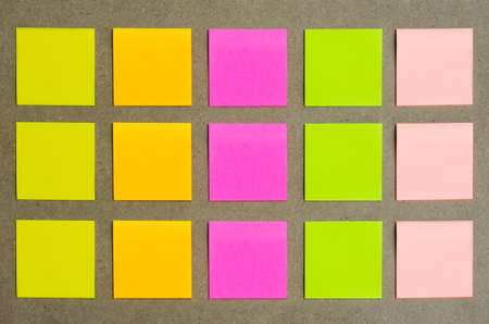 many colorful blank sticky note or empty post notes advertisement top view flat lay on cork board...